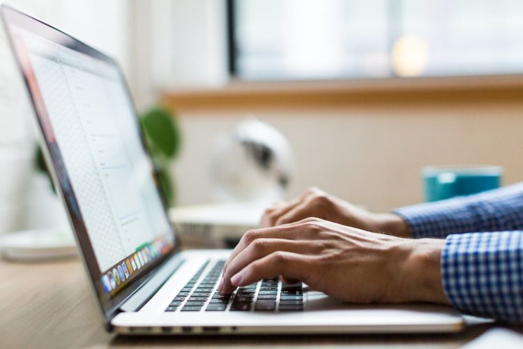 How to Get Free and Affordable Cologne Samples (That Aren’t Sketchy) man encoding on his laptop