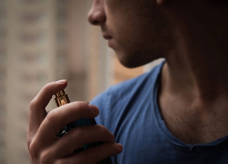 How to Get Free and Affordable Cologne Samples (That Aren’t Sketchy) Man spraying perfume