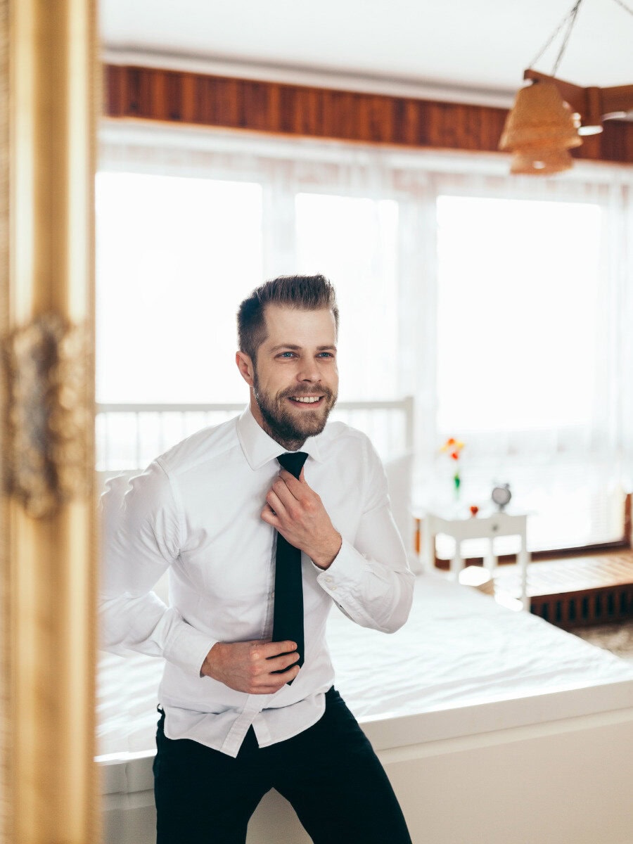 What Does Versace Dylan Blue Smell Like? man getting ready for the office
