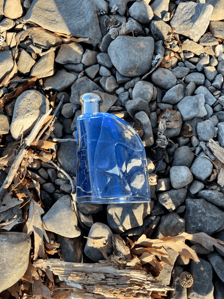 nautica blue - bottle on rocks