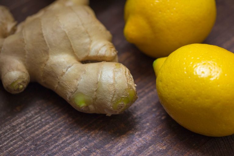 Fresh ginger root beside lemons, capturing gingers zesty citrus-fresh character