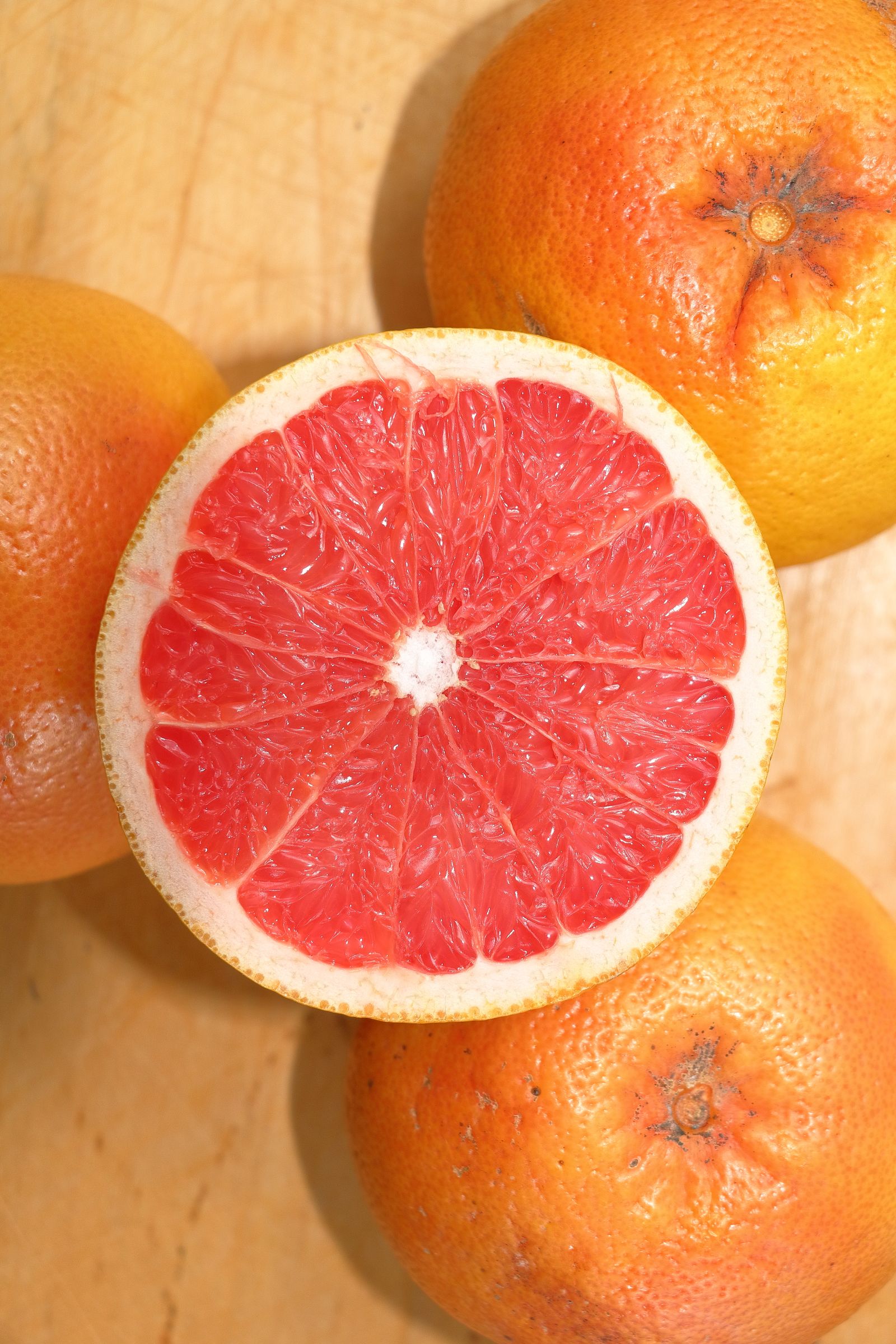 What Does Grapefruit Smell Like? Fresh sliced grapefruit on wood