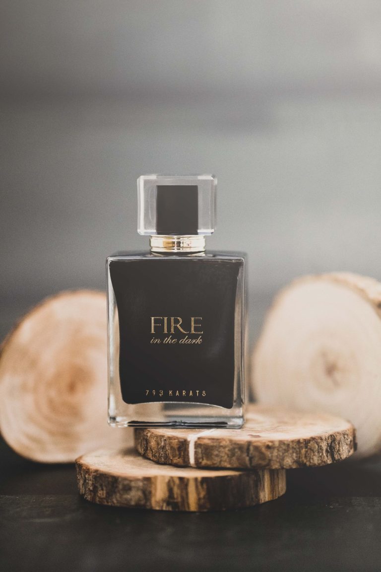Dark masculine cologne bottle on rustic wood