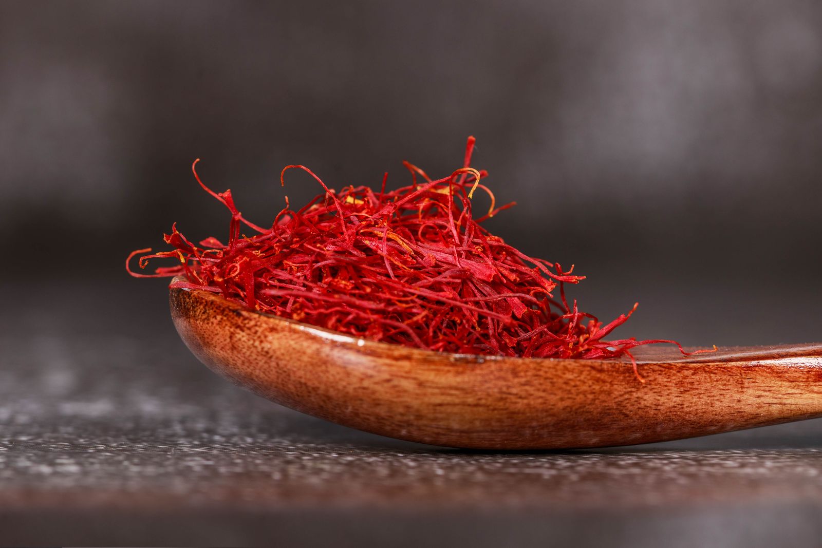 What Does Saffron Smell Like? Leathery, Honeyed & Precious Crimson saffron threads on a wooden spoon