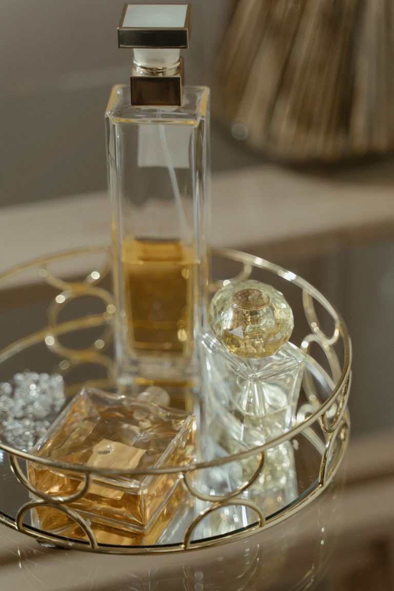 Warm amber perfume bottles on an elegant vanity tray