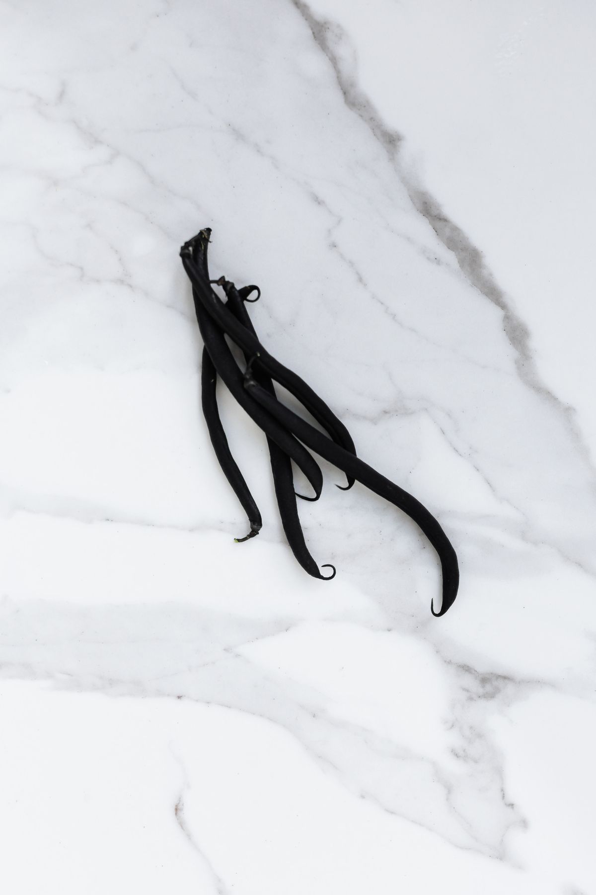 What Does Vanilla Smell Like? Warm, Sweet and Creamy Vanilla beans on a white marble surface