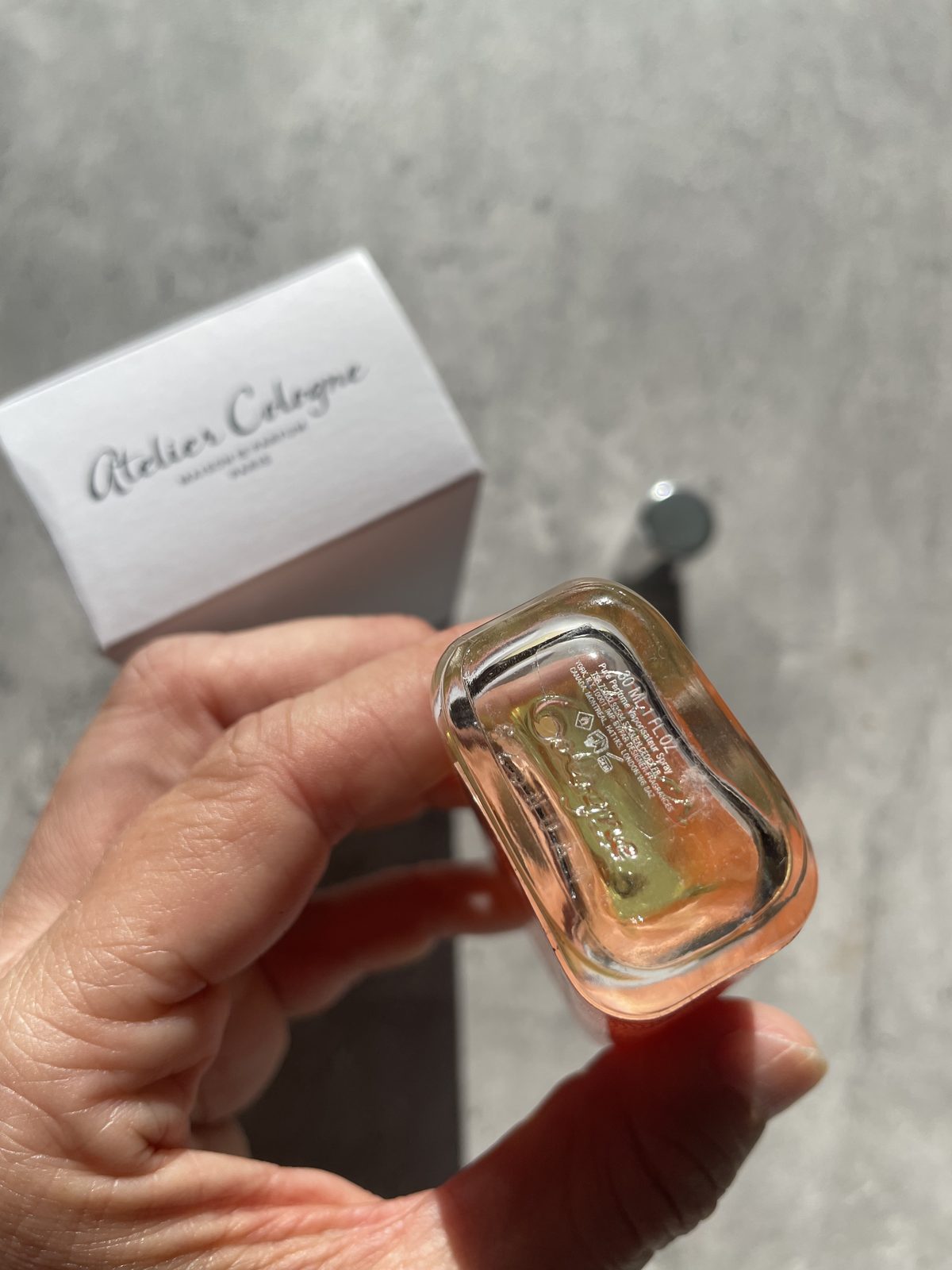 Atelier Cologne Pomelo Paradis Review: The Grapefruit That Stays Holding Atelier Cologne Pomelo Paradis to show the moulded base, 30ml 1 fl oz pure perfume spray