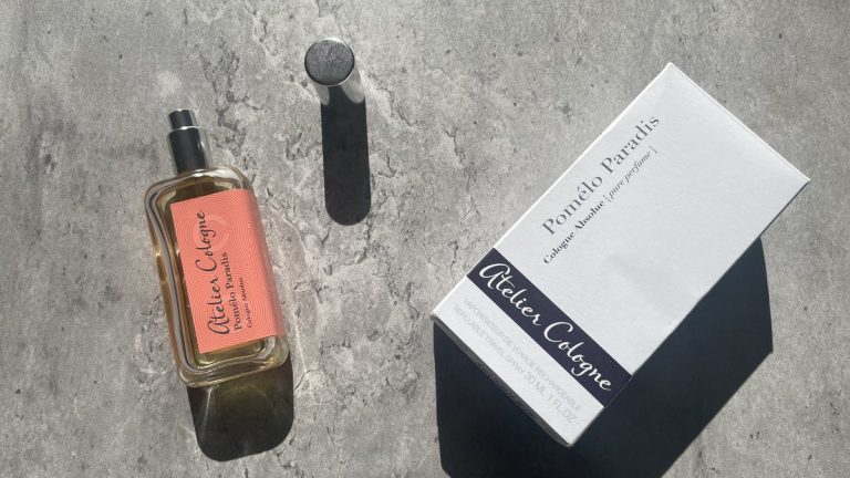 Atelier Cologne Pomelo Paradis Cologne Absolue 30ml bottle, cap and box on sunlit concrete