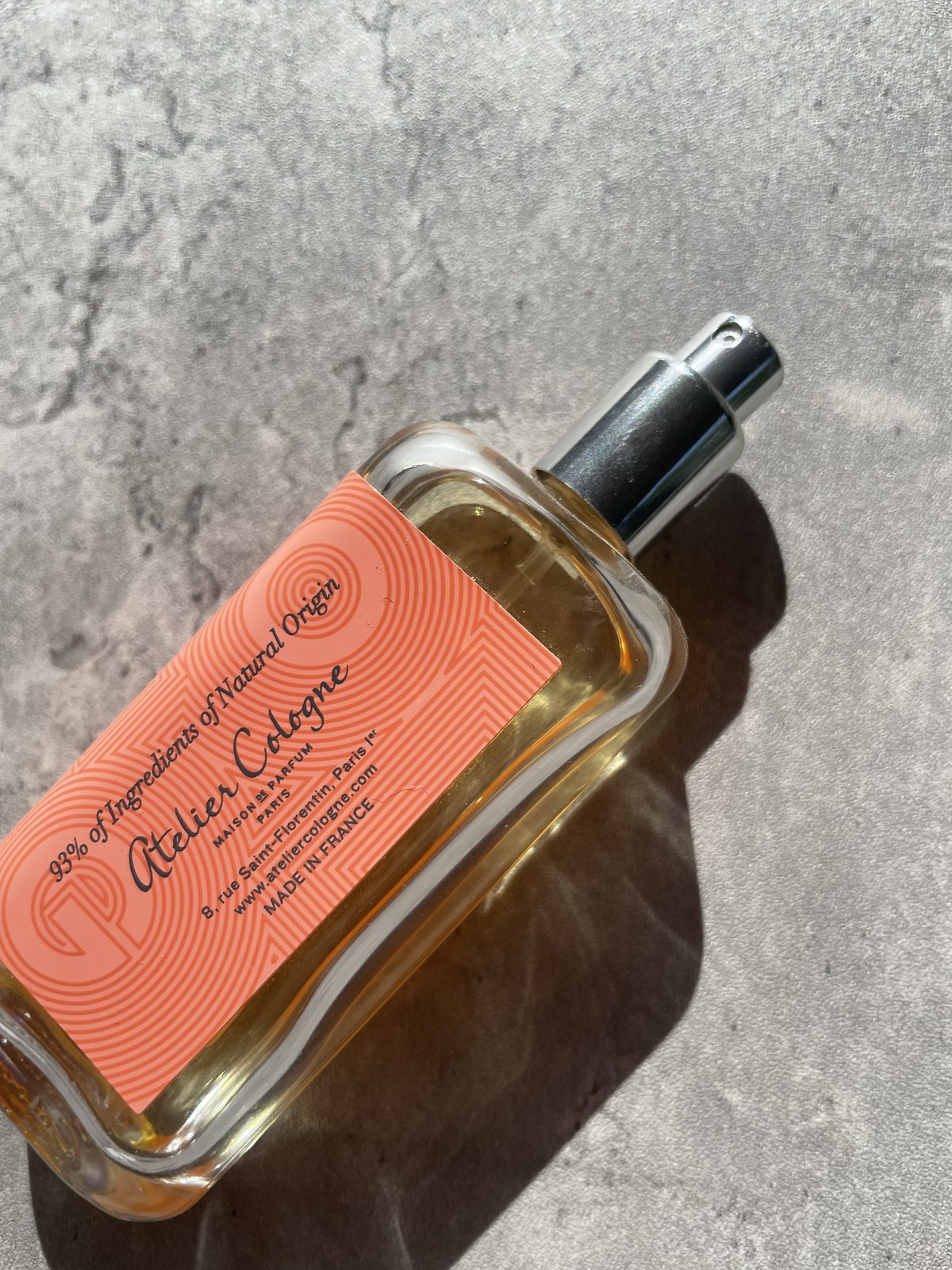 Atelier Cologne Pomelo Paradis Review: The Grapefruit That Stays Close-up of the coral guilloche label on Atelier Cologne Pomelo Paradis, reading 98% ingredients of natural origin, made in France