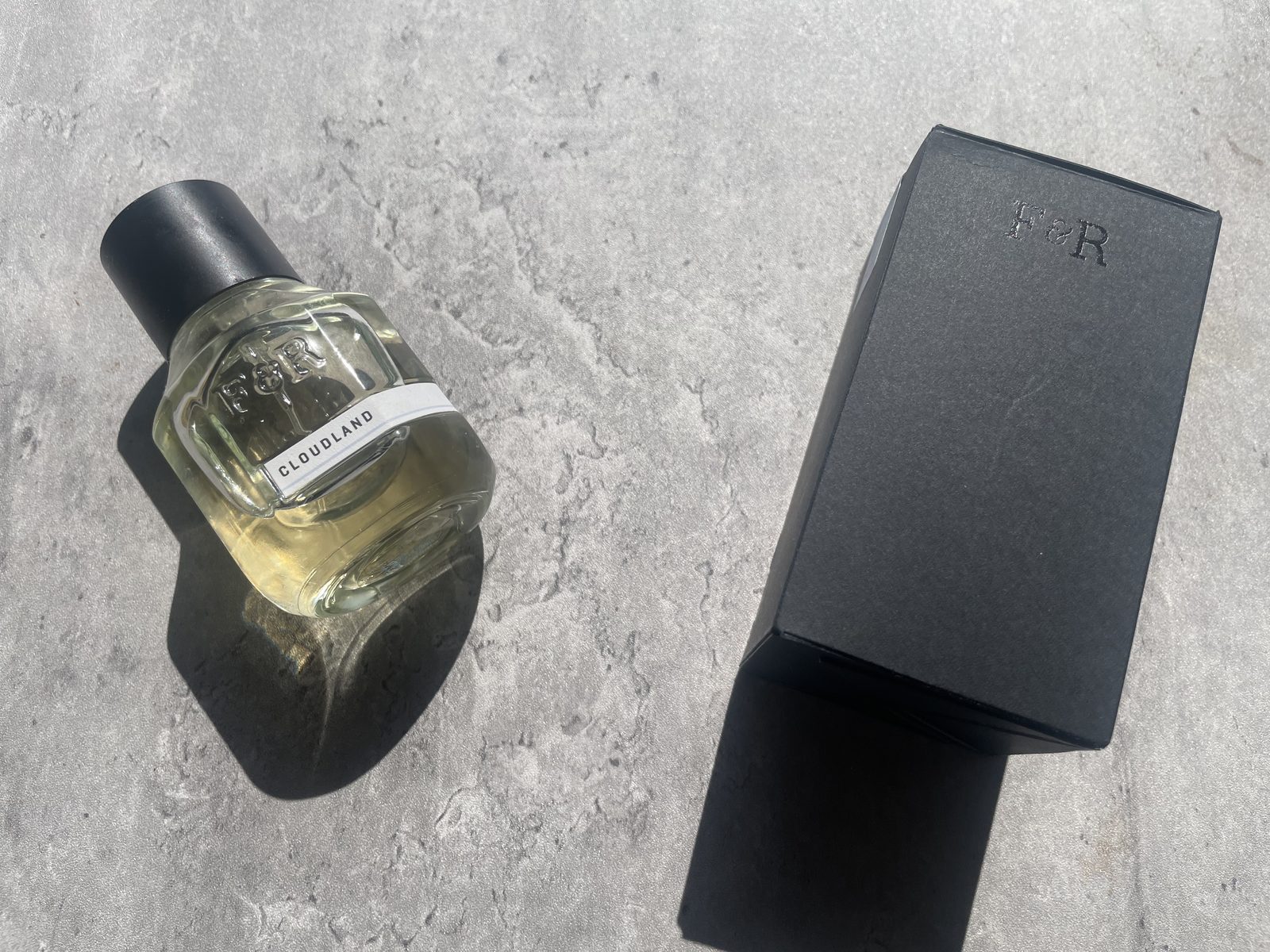 Fulton & Roark Cloudland Review: An Extrait That Won't Call Itself One Fulton & Roark Cloudland bottle and debossed F&R box laid out on concrete