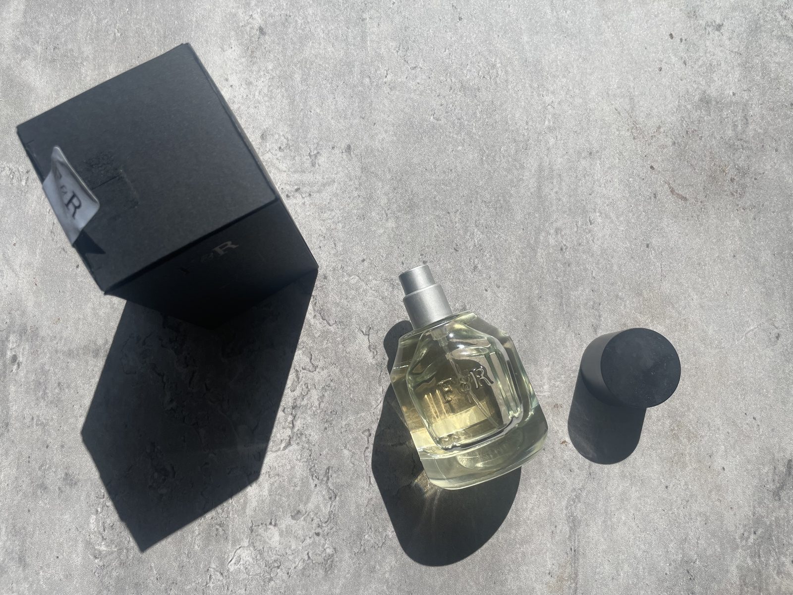 Fulton & Roark Cloudland Review: An Extrait That Won't Call Itself One Fulton & Roark Cloudland bottle, cap and box laid out on sunlit concrete