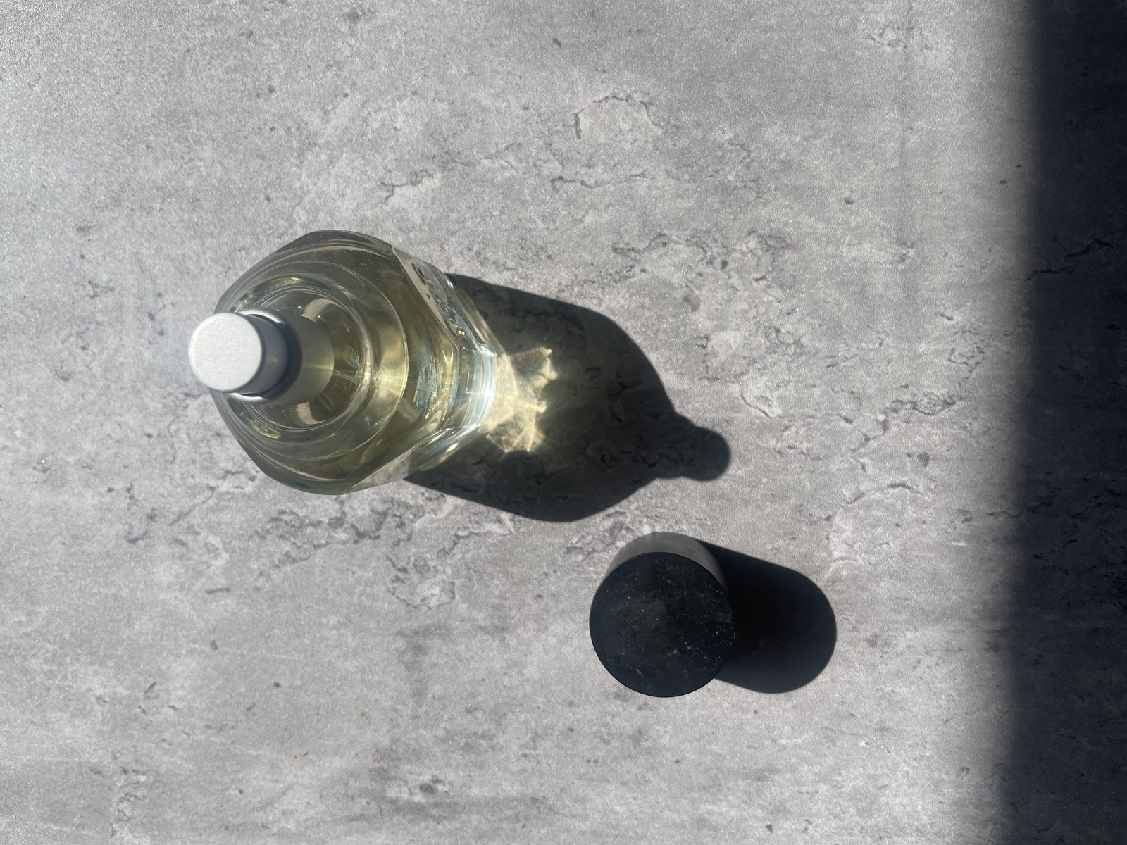 Fulton & Roark Cloudland Review: An Extrait That Won't Call Itself One Sunlight focused through the Fulton & Roark Cloudland bottle, throwing a bright caustic pattern inside its own shadow