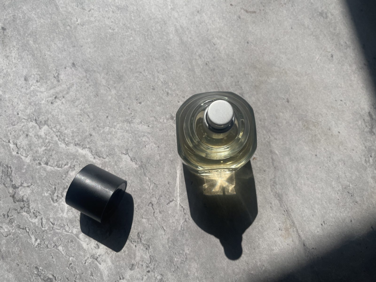 Fulton & Roark Cloudland Review: An Extrait That Won't Call Itself One Fulton & Roark Cloudland shot from directly above with the cap set aside, gold shadow on concrete