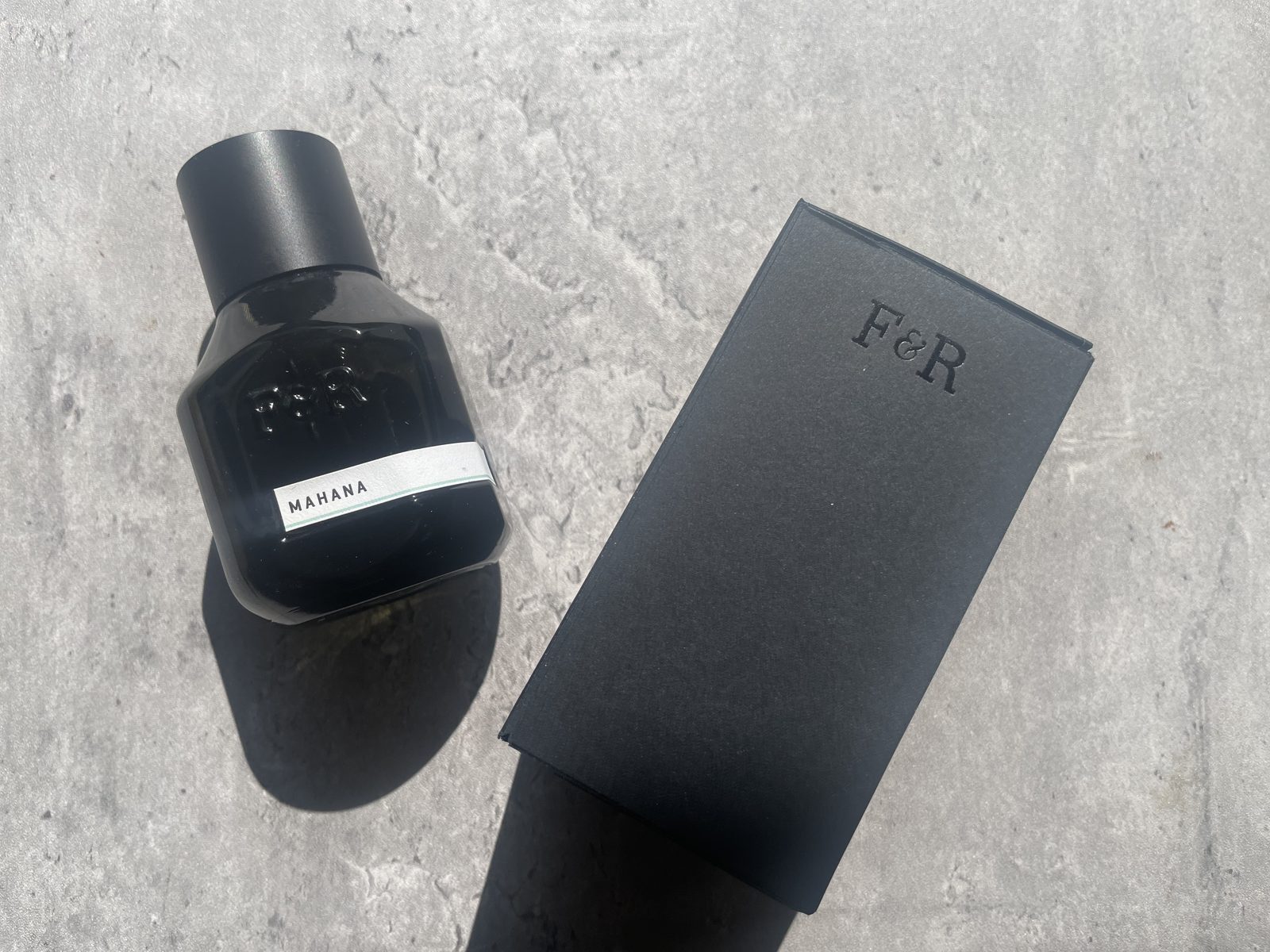 Fulton & Roark Mahana Review: The Same Missing Word as Cloudland Fulton & Roark Mahana 50ml bottle with the cap on beside its debossed F&R box on sunlit concrete