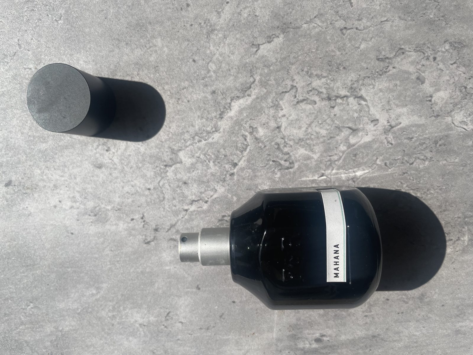 Fulton & Roark Mahana Review: The Same Missing Word as Cloudland Fulton & Roark Mahana 50ml bottle with the MAHANA label facing camera and its matte cap set aside on concrete