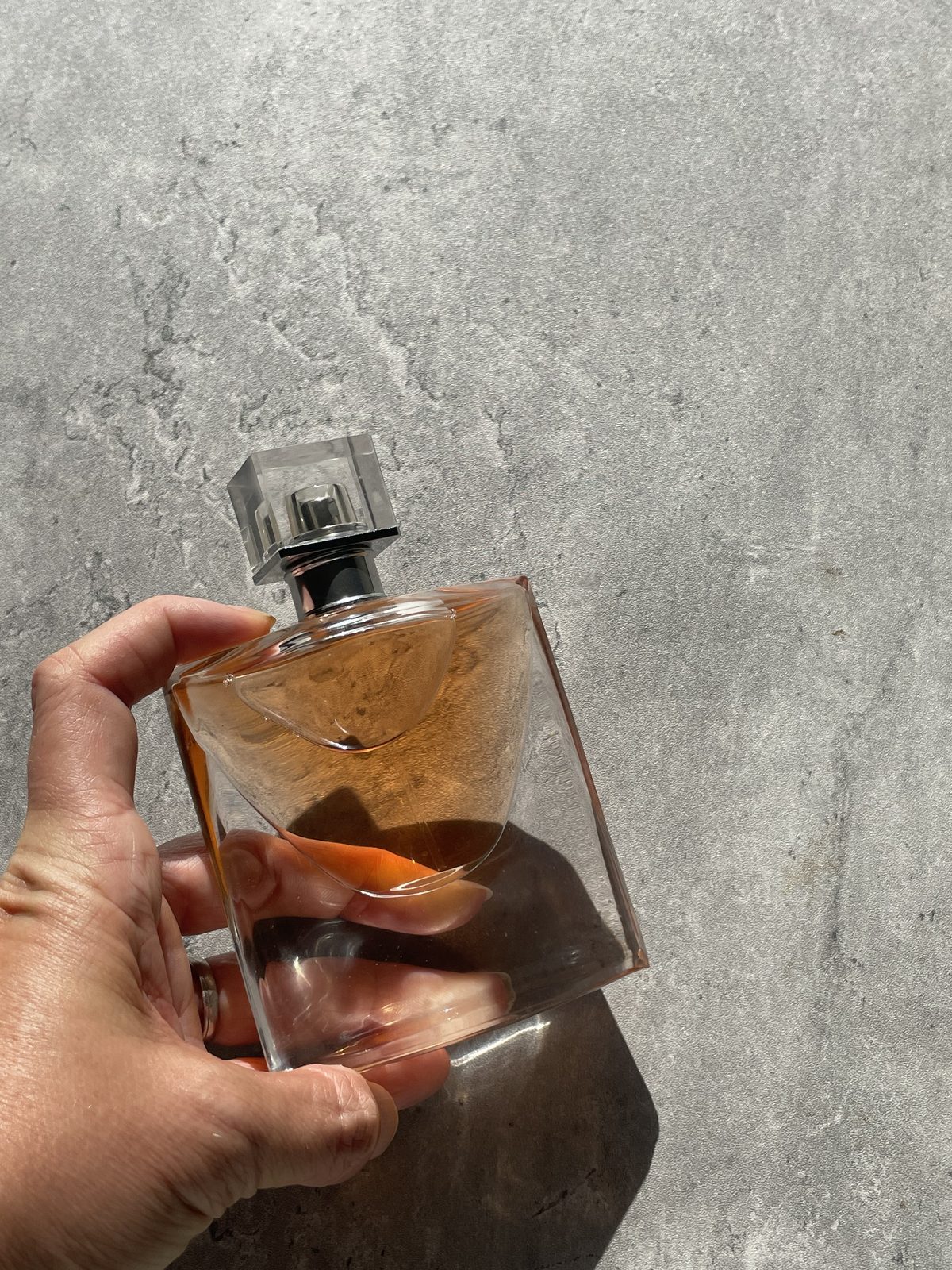 Lancome La Vie Est Belle: Honest Review Holding the Lancome La Vie Est Belle bottle to show its scale