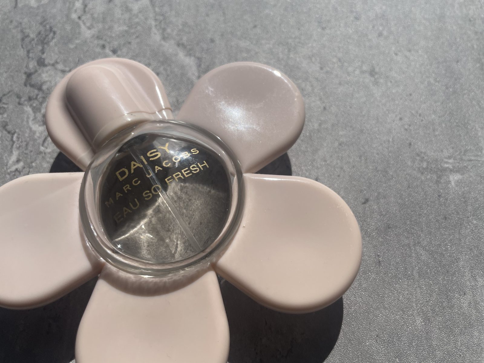 Marc Jacobs Daisy Eau So Fresh Review: The Flanker That Outgrew Daisy Top-down view of the Marc Jacobs Daisy Eau So Fresh flower cap with the gold lettering readable through the glass dome