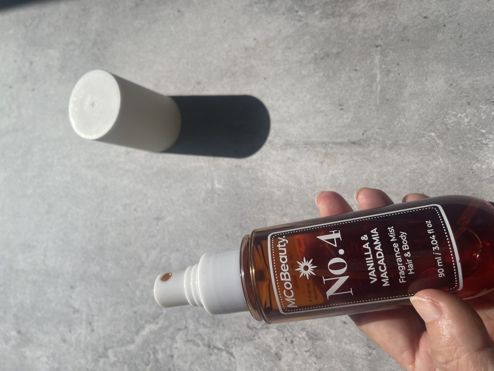 MCoBeauty No.4 Vanilla & Macadamia Review: What the Back Panel Says Holding MCoBeauty No.4 Vanilla & Macadamia, 90 ml / 3.04 fl oz hair and body fragrance mist