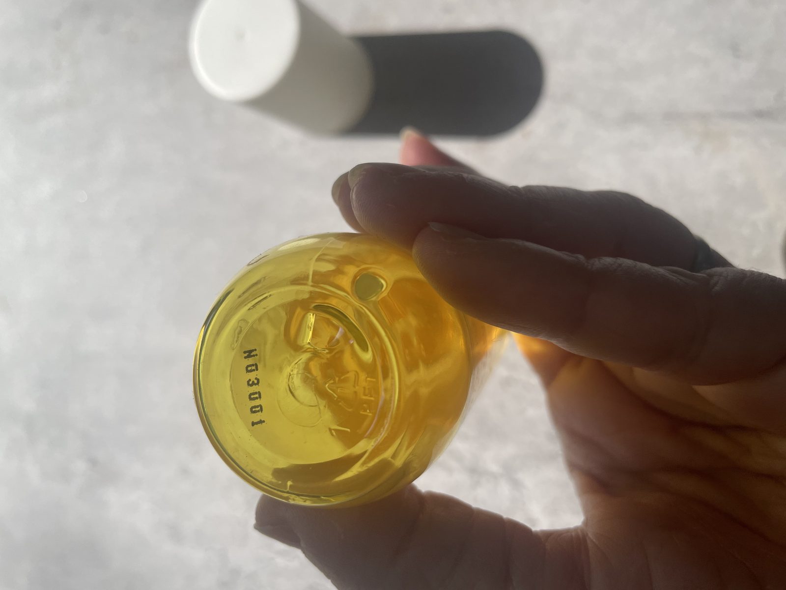 MCoBeauty No.6 Coconut Cream Review: The Batch Code Its Sibling Hides Base of the MCoBeauty No.6 bottle showing batch code N03001