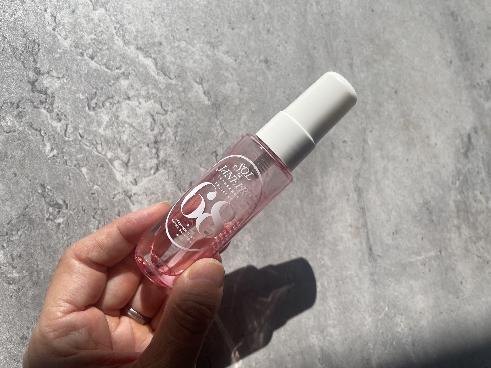 Sol de Janeiro Cheirosa 68 Review: The One That Isn't Pistachio Holding the Sol de Janeiro Cheirosa 68 perfume mist to show its travel size