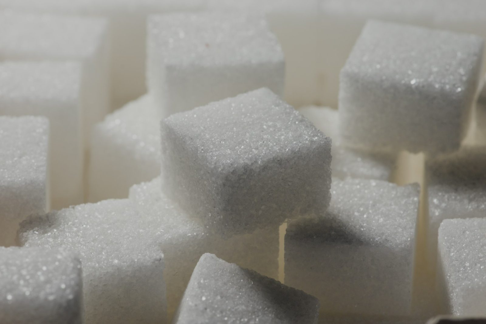 What Does Caramel Smell Like? White sugar cubes stacked in close-up, the raw material behind every caramel accord